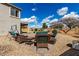 Outdoor seating arrangement with a swing and other furniture, all set on a brick patio within a landscaped backyard at 2562 E Oxford Ct, Gilbert, AZ 85295