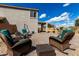 Outdoor furniture on a brick patio, landscaped backyard, a swing, and direct access to the house at 2562 E Oxford Ct, Gilbert, AZ 85295