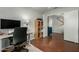 Bedroom with a dedicated workspace featuring a desk, monitor, and view to the home's stairs at 2562 E Oxford Ct, Gilbert, AZ 85295