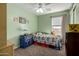 bedroom featuring a ceiling fan, a window with blinds, and a small desk at 2562 E Oxford Ct, Gilbert, AZ 85295