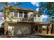 Charming two-story home featuring a two-car garage and a welcoming covered porch with seating area at 2562 E Oxford Ct, Gilbert, AZ 85295