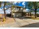 Charming two-story home featuring a two-car garage and a welcoming covered porch with seating area at 2562 E Oxford Ct, Gilbert, AZ 85295