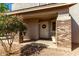 Cozy front porch entrance with brick pillars, a decorative wreath, and charming potted plants at 2562 E Oxford Ct, Gilbert, AZ 85295