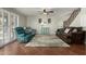 Warm and inviting living room featuring tiled floors, a comfortable seating arrangement, and staircase at 2562 E Oxford Ct, Gilbert, AZ 85295