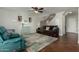 Inviting living room featuring tile floors, a cozy seating arrangement, and staircase at 2562 E Oxford Ct, Gilbert, AZ 85295