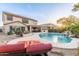 Gorgeous backyard with lounge chairs surrounding a swimming pool featuring a rock waterfall at 2708 E Desert Rose Trl, San Tan Valley, AZ 85143