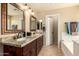 Well-lit bathroom features dual sinks, granite counters, and a separate tub at 2708 E Desert Rose Trl, San Tan Valley, AZ 85143