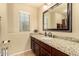 Modern bathroom with granite counters, under-mount sink, and a large mirror at 2708 E Desert Rose Trl, San Tan Valley, AZ 85143