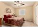 Cozy bedroom featuring neutral tones, a ceiling fan, and a window offering natural light at 2708 E Desert Rose Trl, San Tan Valley, AZ 85143