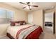 Bedroom with neutral carpet, standard ceiling fan, and attached bathroom at 2708 E Desert Rose Trl, San Tan Valley, AZ 85143