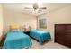 Cozy bedroom with twin beds, side table, and a window for natural light at 2708 E Desert Rose Trl, San Tan Valley, AZ 85143