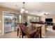 Comfortable dining area with a view of the covered patio and sparkling pool at 2708 E Desert Rose Trl, San Tan Valley, AZ 85143