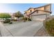 Lovely two-story home featuring manicured landscaping, a spacious driveway, and an attached two-car garage at 2708 E Desert Rose Trl, San Tan Valley, AZ 85143