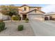 Charming two-story home showcasing a well-manicured front yard, desert landscaping, and an attached two-car garage at 2708 E Desert Rose Trl, San Tan Valley, AZ 85143