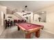 Open game room boasts a pool table, upstairs landing, and an adjacent seating area at 2708 E Desert Rose Trl, San Tan Valley, AZ 85143