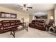 Inviting living room with plush leather seating, and open access to a modern kitchen at 2708 E Desert Rose Trl, San Tan Valley, AZ 85143