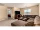 Comfortable living room with neutral walls, plush carpet, and a view to the bedroom at 2708 E Desert Rose Trl, San Tan Valley, AZ 85143