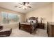 Serene bedroom featuring neutral tones, ceiling fan, and plush carpet flooring at 2708 E Desert Rose Trl, San Tan Valley, AZ 85143