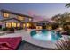 Backyard swimming pool featuring a rock waterfall feature, patio seating, and well-manicured landscaping at 2708 E Desert Rose Trl, San Tan Valley, AZ 85143