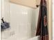 The shower features sleek design, a built-in shelf, and a shower curtain for a clean and modern look at 2708 E Desert Rose Trl, San Tan Valley, AZ 85143