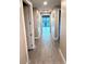 Hallway featuring hardwood flooring leading to natural sunlight at 2734 N Trevino Pl, Mesa, AZ 85215