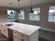 Kitchen island with quartz countertops, stainless steel appliances, and a view of the neighborhood at 2734 N Trevino Pl, Mesa, AZ 85215