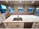 Kitchen island featuring quartz counters, stainless steel dishwasher, and a basin sink at 2734 N Trevino Pl, Mesa, AZ 85215