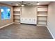 Bright living room featuring custom shelving, cabinets, and hardwood flooring at 2734 N Trevino Pl, Mesa, AZ 85215