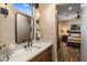 Modern bathroom with a white countertop, dark wood cabinets, and decorative elements next to the sink at 30416 N 64Th Street --, Cave Creek, AZ 85331