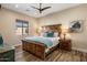 Bedroom features a wooden accent wall, ceiling fan, and matching wooden nightstands at 30416 N 64Th Street --, Cave Creek, AZ 85331