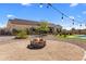 Outdoor firepit area featuring desert landscaping and view of the home and pool at 30416 N 64Th Street --, Cave Creek, AZ 85331