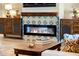 Cozy living room with a fireplace featuring decorative tiles, wood mantle, and custom built in cabinets at 30416 N 64Th Street --, Cave Creek, AZ 85331