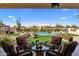 Outdoor living space features a covered patio with a desert landscape, pool and waterfall feature at 30416 N 64Th Street --, Cave Creek, AZ 85331