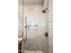 Elegant glass walk-in shower featuring marble tiling, rainfall shower head, and bronze shower fixtures at 30416 N 64Th Street --, Cave Creek, AZ 85331