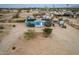 Bird's-eye view of the light blue home featuring solar panels, shrubs, and a concrete driveway at 30446 W Portland St, Buckeye, AZ 85396