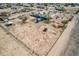 High aerial view of a blue house and a fenced in property located in a community at 30446 W Portland St, Buckeye, AZ 85396