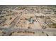 A high-angle aerial view showcases the home's expansive fenced in property and neighborhood at 30446 W Portland St, Buckeye, AZ 85396