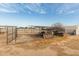 Backyard with metal fencing and miscellaneous items with a dry, dirt yard at 30446 W Portland St, Buckeye, AZ 85396