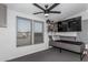 Bedroom features ceiling fan, two windows, and light grey carpet at 30446 W Portland St, Buckeye, AZ 85396