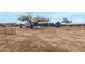 Wide shot of a light blue house with a large yard and an RV on the left at 30446 W Portland St, Buckeye, AZ 85396