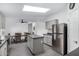 Kitchen with island opens to the dining area with stainless steel refrigerator at 30446 W Portland St, Buckeye, AZ 85396