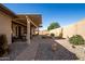 Spacious backyard with covered patio, desert landscaping, and stone pathway at 3061 S Elderwood --, Mesa, AZ 85212