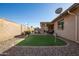 Entertainer's backyard with putting green, covered patio, and desert landscaping at 3061 S Elderwood --, Mesa, AZ 85212