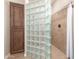 Shower with glass block surround and tiled walls, plus wood cabinet at 3061 S Elderwood --, Mesa, AZ 85212