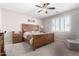 Relaxing bedroom featuring a wood-frame bed with a neutral color scheme and shuttered windows at 3061 S Elderwood --, Mesa, AZ 85212