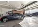 Spacious garage with car, storage cabinets, and open door at 3061 S Elderwood --, Mesa, AZ 85212