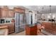 A spacious kitchen featuring stainless steel appliances and a central island with wood cabinets at 3061 S Elderwood --, Mesa, AZ 85212