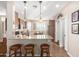 Open kitchen with granite countertops, dark wood cabinets, and a view into the dining area at 3061 S Elderwood --, Mesa, AZ 85212