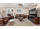 Cozy living room with neutral walls, plush carpeting, and comfortable brown leather furniture at 3061 S Elderwood --, Mesa, AZ 85212