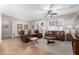 Spacious living room featuring a ceiling fan and comfortable brown furniture with neutral walls and floor at 3061 S Elderwood --, Mesa, AZ 85212